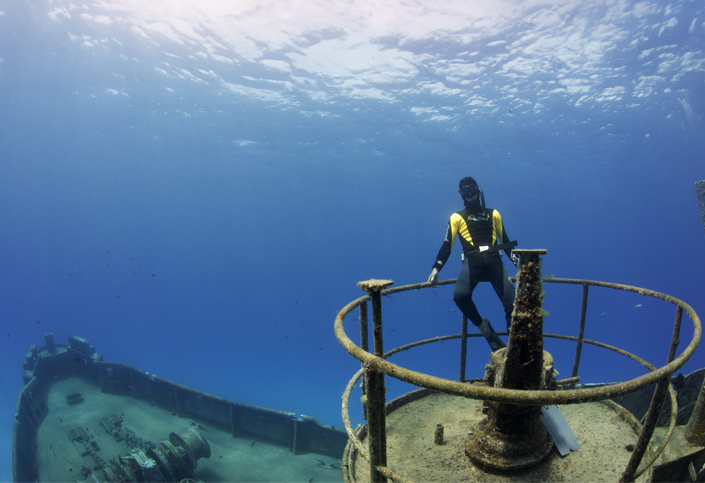 diver posing at the wheel house on Kittiwake deck